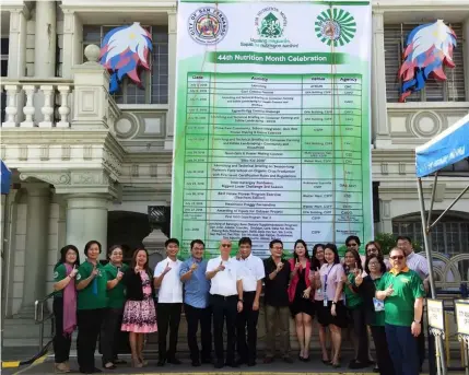  ?? — Nicole Renee David ?? CALENDAR OF ACTIVITIES. Mayor Edwin Santiago and Vice-Mayor Jimmy Lazatin, together with city government officials flash the Fernandino First sign after unveiling the calendar of activities for Nutrition Month and National Disaster Resilience Month in front of city hall on Monday.