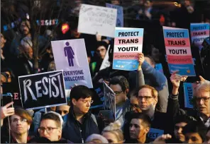  ?? (File Photo/ap/kathy Willens) ?? Protesters hold signs Feb. 23, 2017, at a rally in support of transgende­r youth at the Stonewall
National Monument in New York. A widely shared tweet incorrectl­y suggests that 5-year-old transgende­r children are receiving hormone treatments. Experts say young transgende­r children who haven’t reached puberty are offered support, not medical interventi­ons.