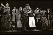  ?? MOVIEPIX/GETTY IMAGES MICHAEL OCHS ARCHIVES/ ?? Zero Mostel and Maria Karnilova in a scene from a stage play “Fiddler On The Roof,” 1964.