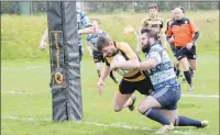  ??  ?? Callum Boyd crashes his way over the line for a try.