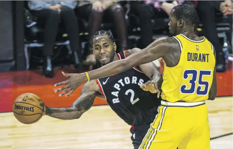  ?? ERNEST DOROSZUK ?? The Raptors’ Kawhi Leonard tries to move the ball against Golden State Warrior Kevin Durant during Toronto’s 131-128 overtime win at Scotiabank Arena on Thursday.