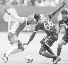  ?? THE CANADIAN PRESS ?? New England Revolution’s Teal Bunbury, left, and Vancouver Whitecaps’ Ali Ghazal vie for the ball.