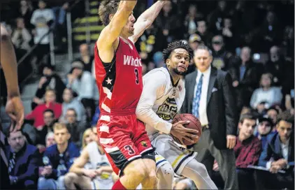  ?? ST. JOHN’S EDGE PHOTO/JEFF PARSONS ?? Charles Hinkle of the St. John’s Edge tries to drive past Logan Stutz (left) of the Windsor Express during a National Basketball League of Canada game at Mile One Centre earlier this season as St. John’s head coach Jeff Dunlap looks on in the...