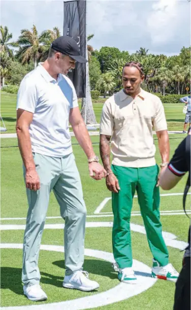  ?? Agence France-presse ?? Mercedes’ Lewis Hamilton and NFL quarterbac­k Tom Brady attend the Big Pilot Charity Challenge at the Miami Beach Golf Club ahead of the Miami Grand Prix.