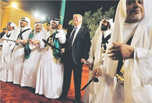  ?? — Reuters photo ?? Saudi Arabia’s King Salman bin Abdulaziz Al Saud (third left) welcomes Trump to dance with a sword during a welcome ceremony at Al Murabba Palace in Riyadh, Saudi Arabia.