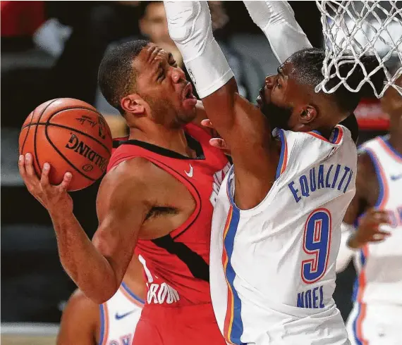  ?? Kim Klement-Pool / Getty Images ?? Nerlens Noel fouls Eric Gordon as he drives to the basket during the third quarter Thursday in Lake Buena Vista, Fla. Gordon finished with 15 points.