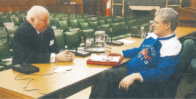  ?? Handout / the canadian press ?? In this photo entered Tuesday into evidence at his trial, Mike Duffy and then-prime minister Stephen Harper talk after a February 2013 caucus meeting.