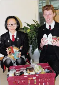  ??  ?? ●● Ji Chen and Joshua Mock from All Hallows with food for the Treehouse project