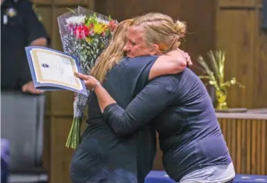  ?? STAFF PHOTO BY OLIVIA ROSS ?? Amy Piercy, left, hugs Paige Robinette, resident manager at The Launch Pad, during Piercy’s graduation from the Hamilton County Drug Recovery Court program Monday.