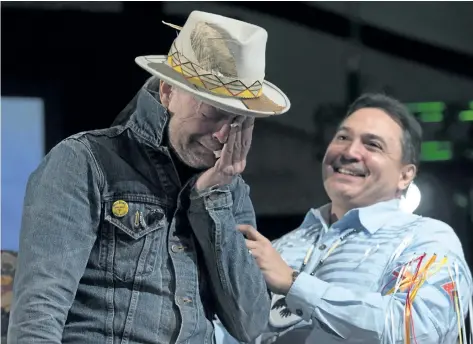  ?? ADRIAN WYLD/THE CANADIAN PRESS FILES ?? Assembly of First Nations Chief Perry Bellegarde holds an emotional Gord Downie as he given an aboriginal name during a ceremony honouring Downie at the AFN Special Chiefs assembly in Gatineau, Que., on Dec. 6, 2016.