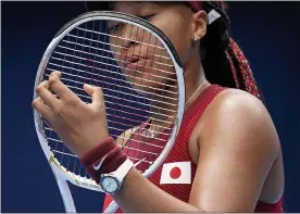 ?? PATRICK SEMANSKY - THE ASSOCIATED PRESS ?? Naomi Osaka, of Japan, adjusts her racket during a second round tennis match against Viktorija Golubic, of Switzerlan­d, at the 2020Summer Olympics, Monday, July 26, 2021, in Tokyo, Japan.