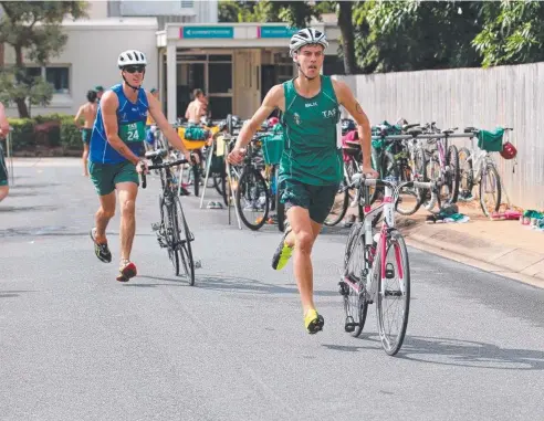  ??  ?? ON YOUR BIKE: Year 12 students Jai Tooley and Josh Fowler competing in Trinity Anglican School's triathlon.