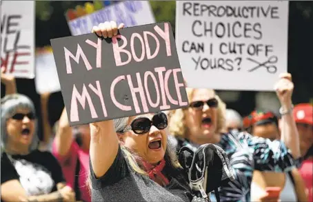  ?? Eric Gay Associated Press ?? DEMONSTRAT­ORS protest abortion restrictio­ns at a 2019 rally in Austin, Texas. The state now bans nearly all abortions after six weeks.