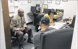  ?? LAURIE KELLMAN / ASSOCIATED PRESS ?? Nathan Singletary (left), 67, listens as employment specialist Luz Rivera interviews Senior Community Service Employment Program participan­t Luis Quinones, 66, at the AARP Foundation in Harrisburg, Pa. The Trump budget seeks to end the senior...