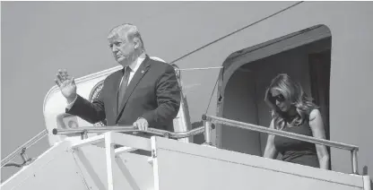  ?? LEAH MILLIS • REUTERS ?? U.S. President Donald Trump and first lady Melania Trump arrive aboard Air Force One at Wright-Patterson Air Force Base before visiting the site of a mass shooting in Dayton, Ohio on Wednesday.