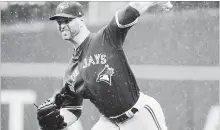  ?? FRANK FRANKLIN II THE ASSOCIATED PRESS ?? Toronto Blue Jays’ J.A. Happ delivers a pitch against the Mets on Wednesday afternoon in New York. The Blue Jays won, 12-1.