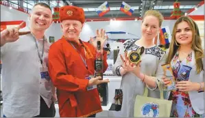  ?? PHOTOS PROVIDED TO CHINA DAILY ?? Russian exhibitors line up with their products at the main venue for the 14th China (Shenzhen) Internatio­nal Cultural Industries Fair in Futian District.