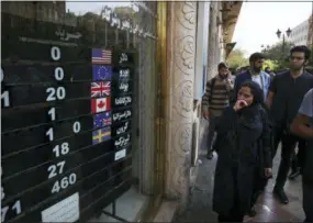  ?? THE ASSOCIATED PRESS ?? An exchange shop displays rates for various currencies Oct. 2 in downtown Tehran, Iran. A battle is brewing between the Trump administra­tion and some of the president’s biggest supporters in Congress who are concerned that sanctions to be re-imposed on Iran early next month won’t be tough enough.