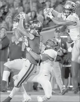  ?? Photograph­s by Luis Sinco Los Angeles Times ?? THE TROJANS’ Michael Pittman catches a pass amid defensive pressure from Colorado’s Delrick Abrams, center, and Evan Worthingto­n.