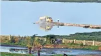  ?? Photo: Justin George ?? A lorry dumping waste in the marshland