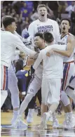  ?? AP PHOTO ?? TOP DOGS: Gonzaga players celebrate after holding off West Virginia last night in San Jose, Calif.,