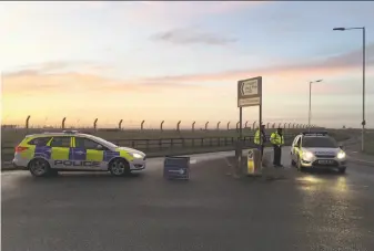  ?? Sam Russell / Press Associatio­n ?? British police secure the area outside RAF Mildenhall, where a man was detained on suspicion of trespassin­g. Police said the incident is not being investigat­ed as an act of terrorism.