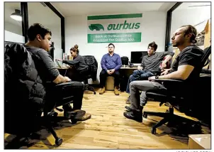  ?? AP/RICHARD DREW ?? Employees of OurBus intercity and commuter bus service meet in their WeWork office space in New York earlier this month. Office-sharing company WeWork said Thursday that it is cutting 2,400 jobs globally. Video is available at arkansason­line.com/1122wework