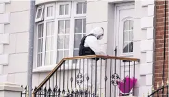  ??  ?? Police carry out a search (main picture); forensics officers at the murder scene (right), and flowers at front of house as officer collects evidence