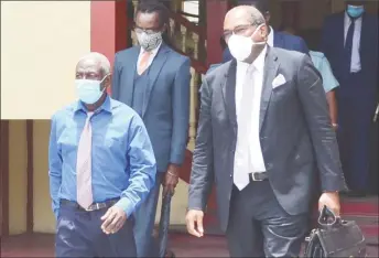  ??  ?? Clairmont Mingo (left) and Attorney Nigel Hughes leaving the court yesterday.