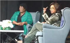  ?? — Reuters photos ?? Winfrey (right and below) takes part in a town hall meeting with Abrams ahead of the mid-term election in Marietta, Georgia on Thursday.