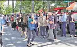  ?? AP ?? Survivors receive medical treatment (top) outside of a hospital in Cianjur, West Java, while people wait outside an office building after being evacuated following an earthquake, at the main business district in Jakarta, Indonesia, on Monday.