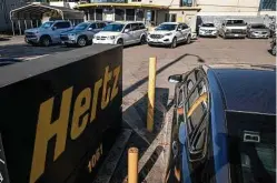  ?? Bloomberg file photo ?? Hertz, one of the largest car rental companies, filed for Chapter 11 bankruptcy and had to sell 182,500 cars to satisfy creditors.