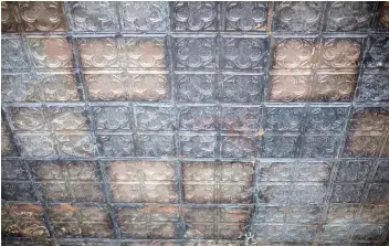  ??  ?? A manufactur­er in Michigan is using a mould of the original tin ceiling tiles to replace the broken ones.