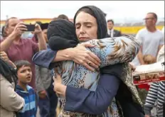  ?? Hagen Hopkins/Getty Images ?? Prime Minister Jacinda Ardern hugs a mosque-goer at the Kilbirnie Mosque on Sunday in Wellington, New Zealand.