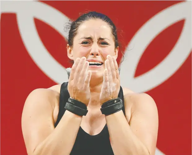  ?? VINCENZO PINTO / AFP VIA GETTY IMAGES ?? Maude Charron reacts with tears of joy during the women’s 64kg weightlift­ing competitio­n Tuesday.