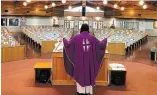  ?? TORSTARFIL­E ?? Rev. Rico Passero, pastor of St. Joseph parish in Grimsby, livestream­s mass in front of pews filled with photos of his parishione­rs.