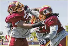  ?? STEVE HELBER / ASSOCIATED PRESS ?? Redskins defensive end Jonathan Allen (left) and nose tackle Ziggy Hood mix it up Monday during practice at training camp in Richmond, Va.