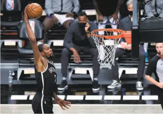  ??  ?? The Nets’ Kevin Durant dunked for two of his 22 points in his first game since the 2019 Finals.