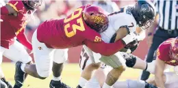  ?? CHARLIE NEIBERGALL/AP ?? Iowa State defensive tackle Isaiah Lee (93) tackles Oklahoma State running back Jaylen Warren on Saturday in Ames, Iowa.