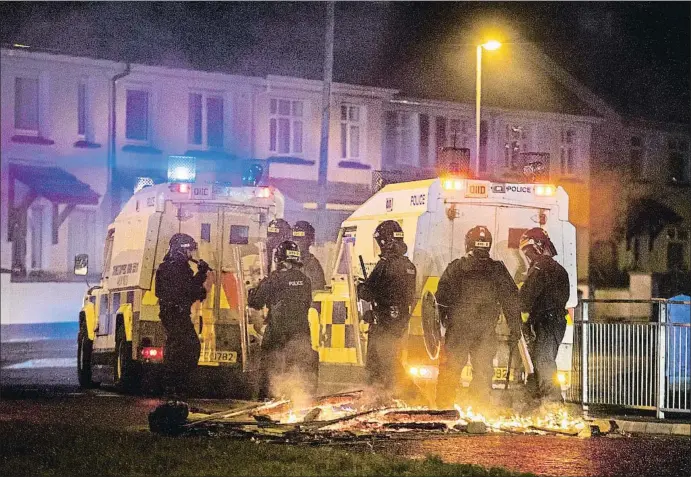  ?? LIAM MCBURNEY / AP ?? Agentes del grupo de apoyo táctico de la policía de Irlanda del Norte desplegado­s en uno de los puntos de la ciudad de Derry donde estallaron los disturbios