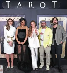  ?? Getty Images ?? Anna Halberg, Avantika, Larsen Thompson, Scott Glassgold and Spenser Cohen seen at the ‘Tarot’ screening in Los Angeles in April. Avantika stars in the Sony Pictures horror film. Left: Avantika wore a peach gown by Lebanese designer Geyanna Youness in Los Angeles.