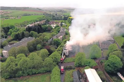  ??  ?? Firefighte­rs in attendance as smoke billows from the former Strathmart­ine Hospital.