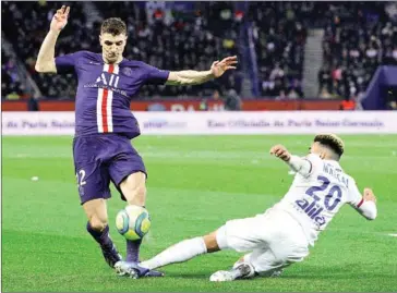  ?? AFP ?? Paris Saint-Germain’s Thomas Meunier fights for the ball against Lyon’s defender Marcal during the French L1 football match between Paris Saint-Germain and Lyon at the Parc des Princes stadium in Paris on Sunday.