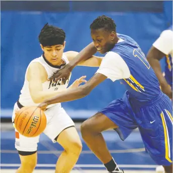  ?? NICK BRANCACCIO ?? The St. Joseph’s Lasers’ Gabriel Rosete, left, loses the ball against the Kennedy Clippers’ Mazin Tiea in a semifinal at the 63rd annual University of Windsor high school tourney at St. Denis Centre Saturday.