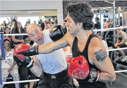  ??  ?? Justin Trudeau spars with Halifax business owner Mickey MacDonald in August 2014.