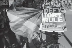  ?? Associated Press ?? People demonstrat­e Saturday at Whitehall, central London, after the British general election result. Prime Minister Theresa May’s party fell short of an overall majority following Thursday’s vot and plans to work with Northern Ireland’s Democratic...