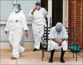  ??  ?? Housekeepe­r Belinda Moore bows her head May 8 as members of Rock Springs Church hold an outdoor prayer service for the long-term care workers battling through the pandemic at Westbury Medical Care and Rehab in Jackson.