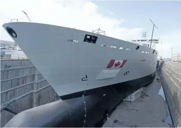  ?? JACQUES BOISSINOT/THE CANADIAN PRESS ?? The Resolve-Class naval support ship Asterix is unveiled at a ceremony at the Davie shipyard in Levis, Que., on Thursday. The Asterix naval support ship will be the largest naval ship ever delivered from a Canadian shipyard.