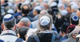  ?? [AP PHOTO] ?? In this Wednesday photo, people wear Jewish skullcaps, or kippa, as they attend a demonstrat­ion against an anti-Semitic attack in Berlin.