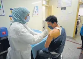  ?? ANDRABI/HT ?? A nurse injecting a vaccine shot to a beneficiar­y at a hospital in Srinagar on Monday.WASEEM